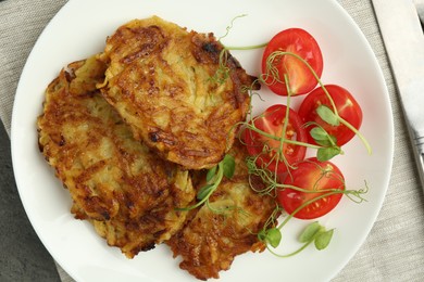 Photo of Delicious potato pancakes with fresh tomatoes and microgreens on grey table, top view