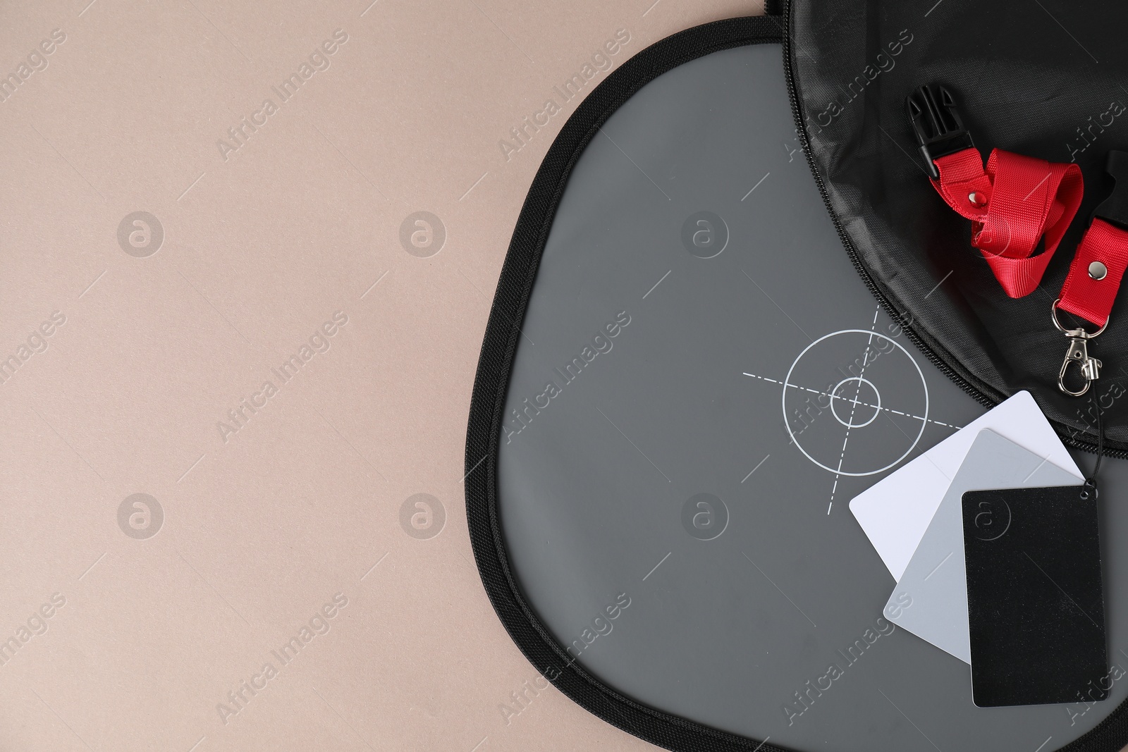 Photo of White balance calibration cards on beige background, top view. Space for text