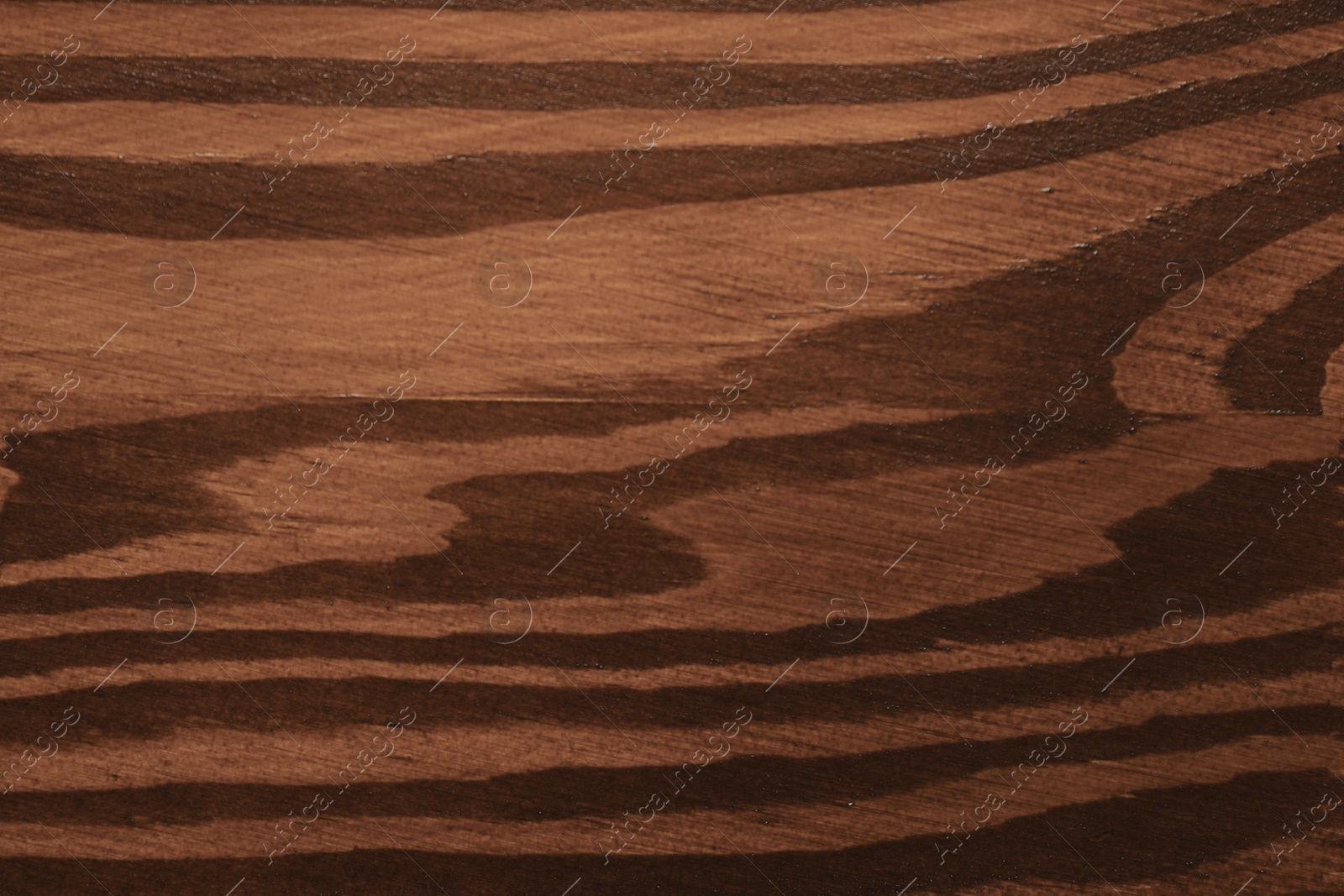 Photo of Texture of wooden surface after applying walnut wood stain as background, top view