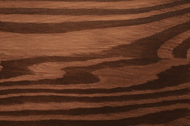 Photo of Texture of wooden surface after applying walnut wood stain as background, top view