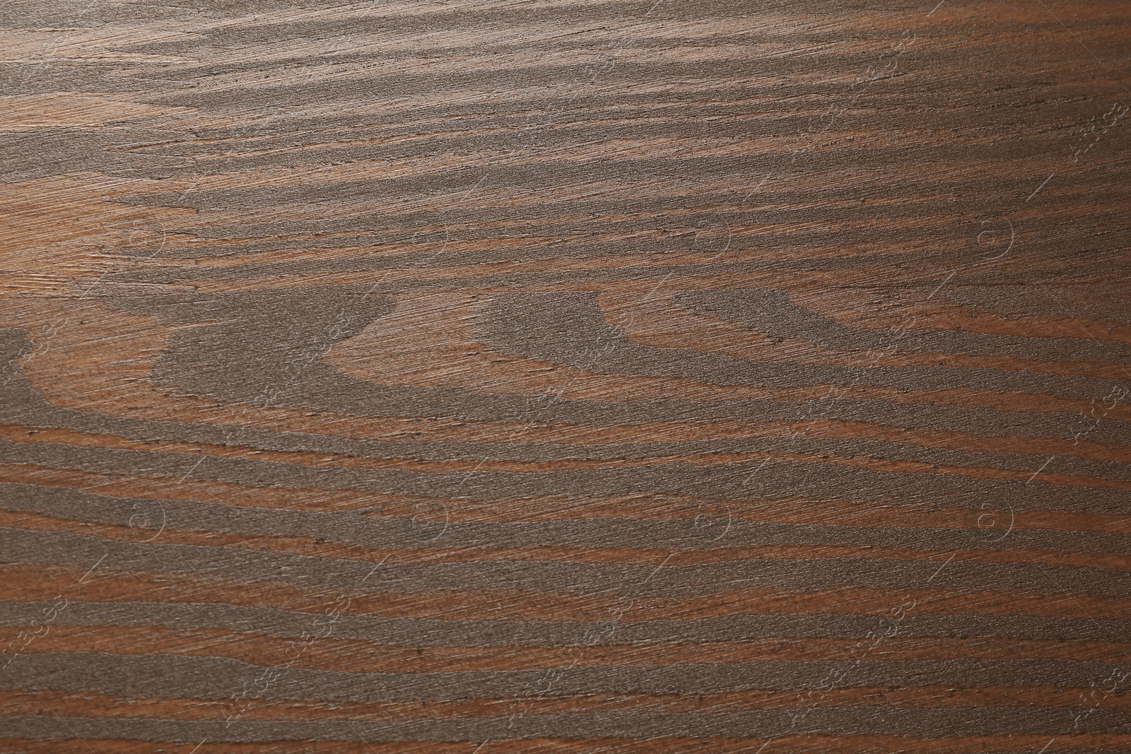 Photo of Texture of wooden surface after applying walnut wood stain as background, top view