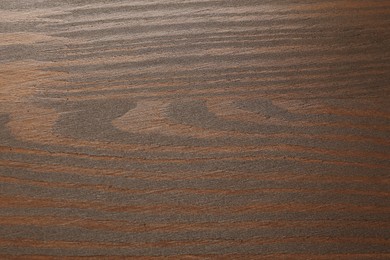 Photo of Texture of wooden surface after applying walnut wood stain as background, top view