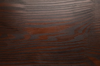 Texture of wooden surface after applying walnut wood stain as background, top view