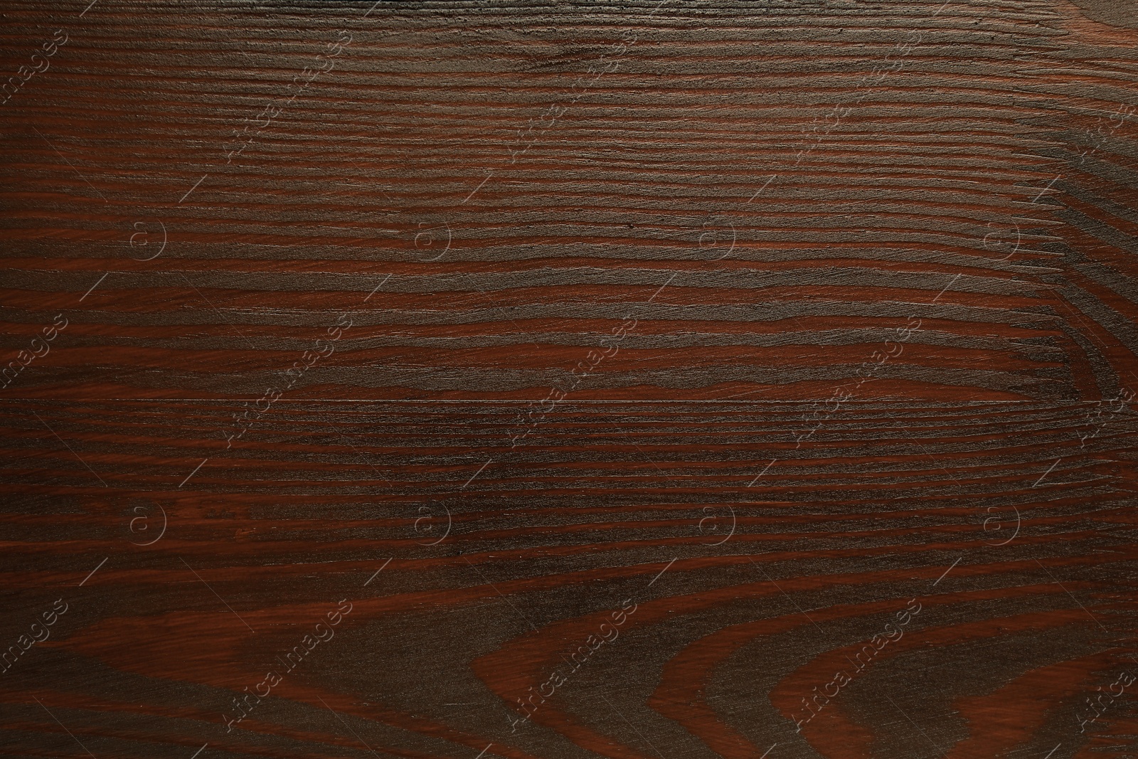 Photo of Texture of wooden surface after applying walnut wood stain as background, top view