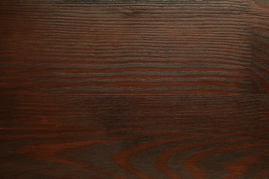 Photo of Texture of wooden surface after applying walnut wood stain as background, top view