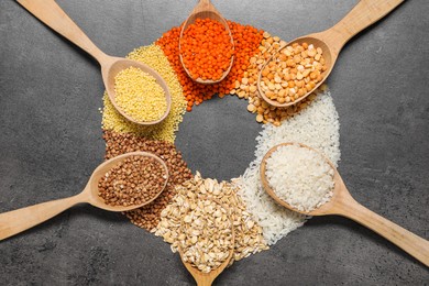 Photo of Different types of cereals and legumes on grey table, flat lay