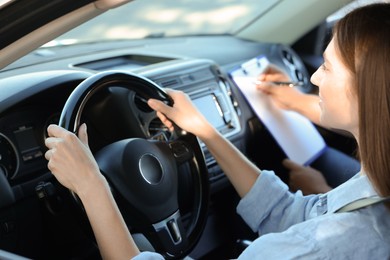 Driving school. Student passing driving test with examiner in car