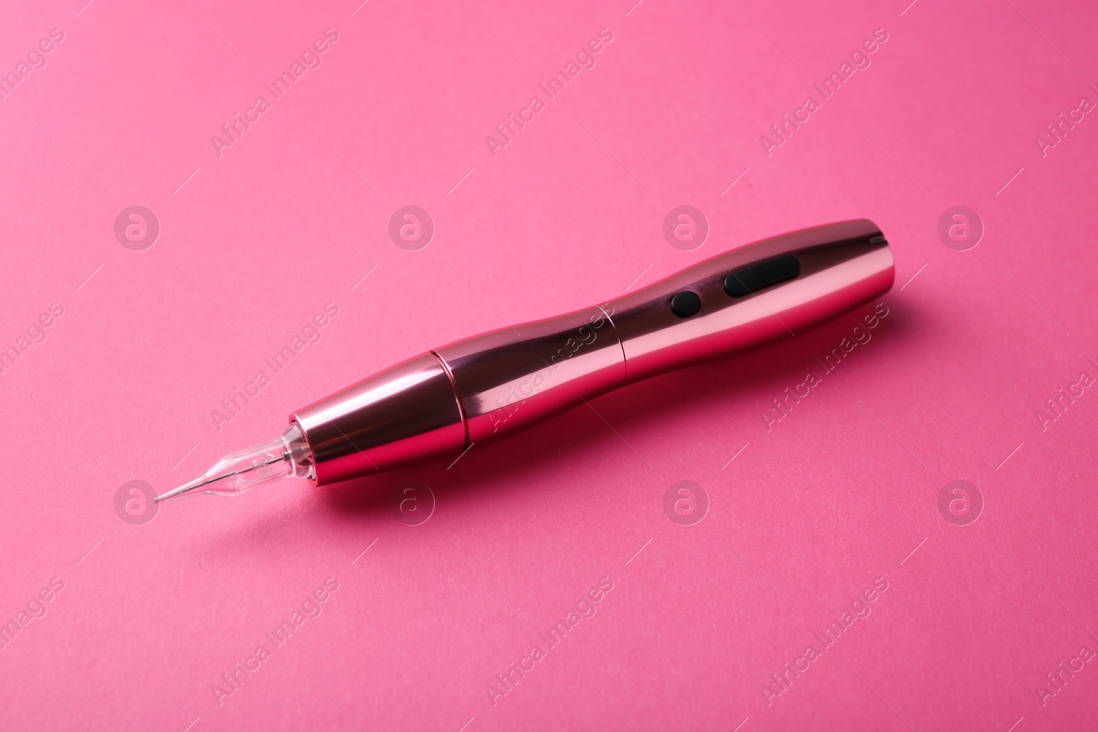 Photo of Professional permanent makeup machine on pink background