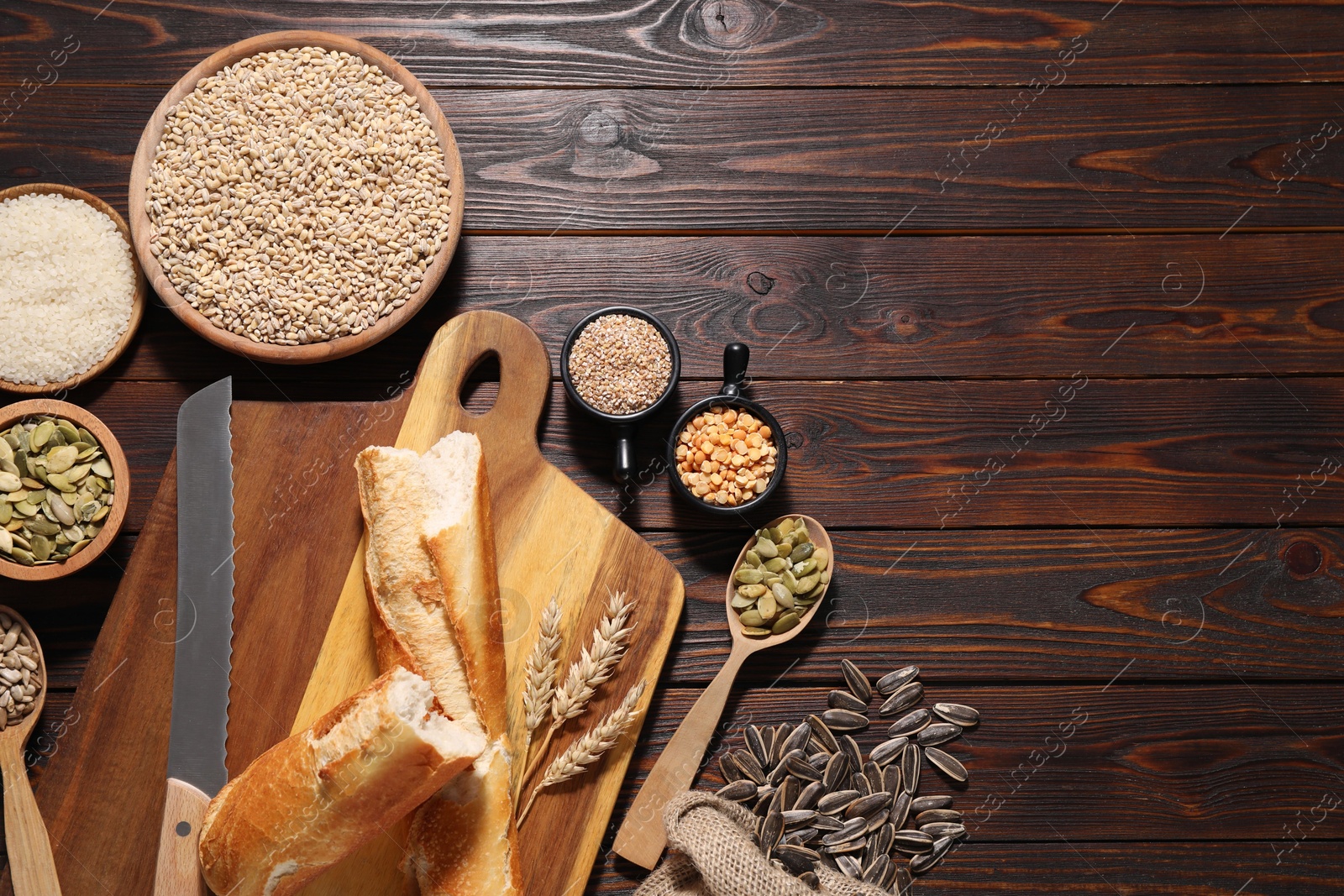 Photo of Different types of cereals, seeds and legumes on wooden table, flat lay. Space for text