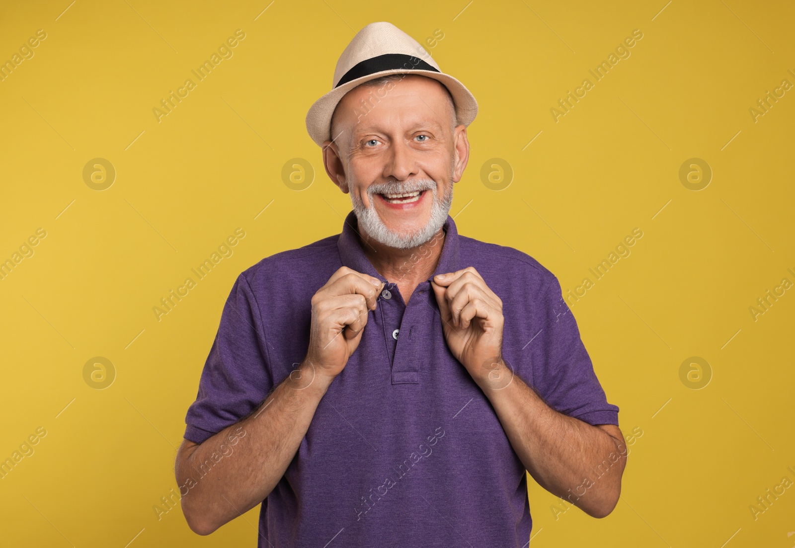 Photo of Portrait of happy senior man on yellow background