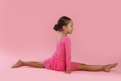 Photo of Portrait of little ballerina on pink background