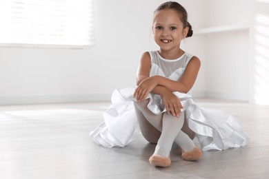 Photo of Portrait of little ballerina indoors, space for text