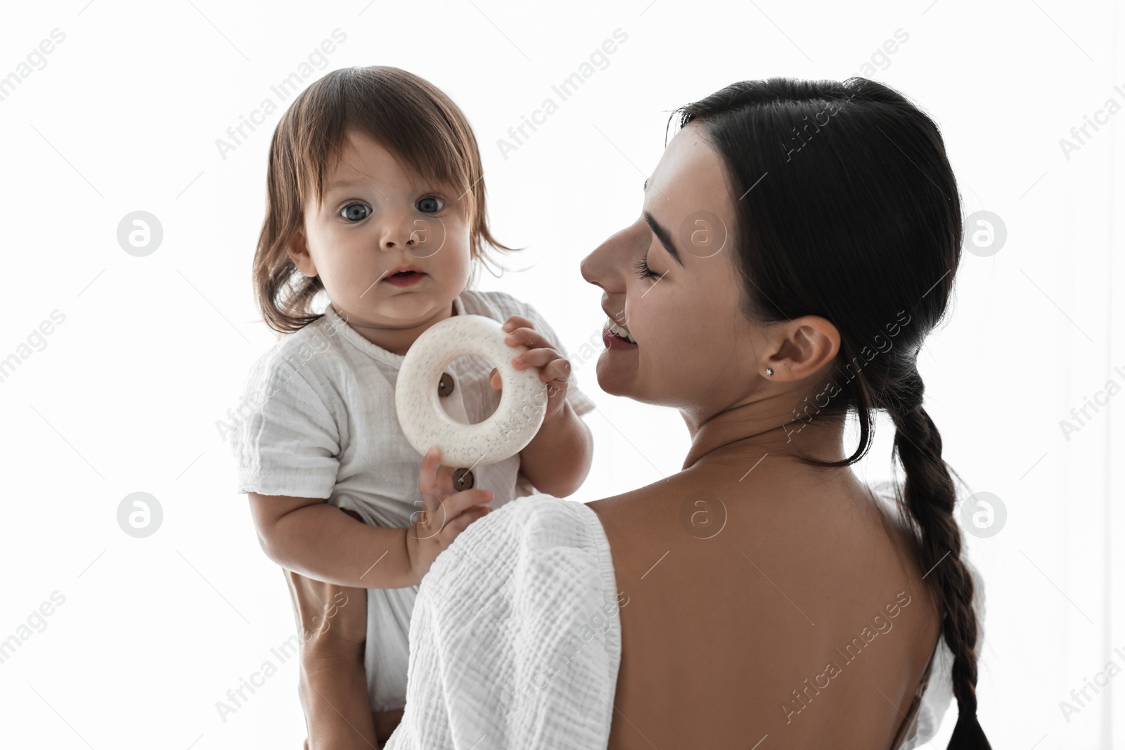 Photo of Beautiful young mother with her cute little baby indoors