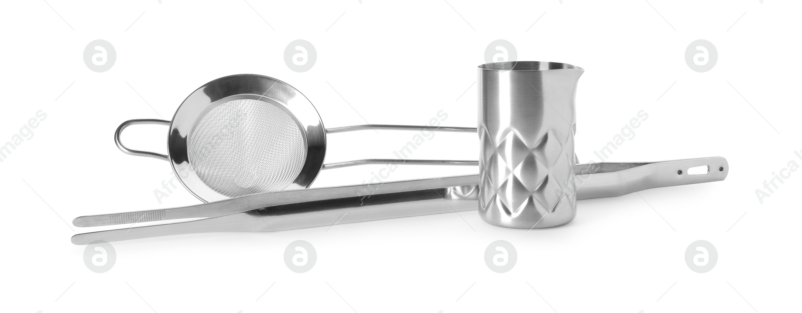 Photo of Metal sieve, tweezers and jigger isolated on white