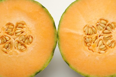 Photo of Halves of Cantaloupe melon on white table, top view