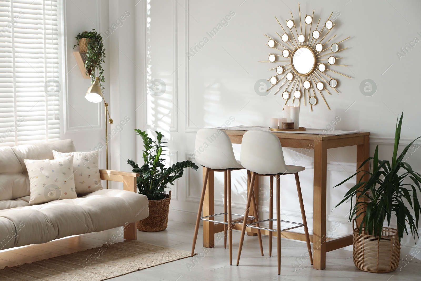 Photo of Bar stools near wooden table in room