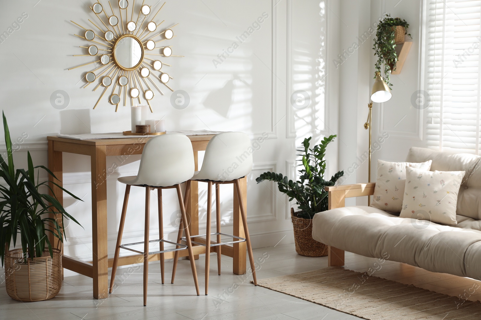 Photo of Bar stools near wooden table in room