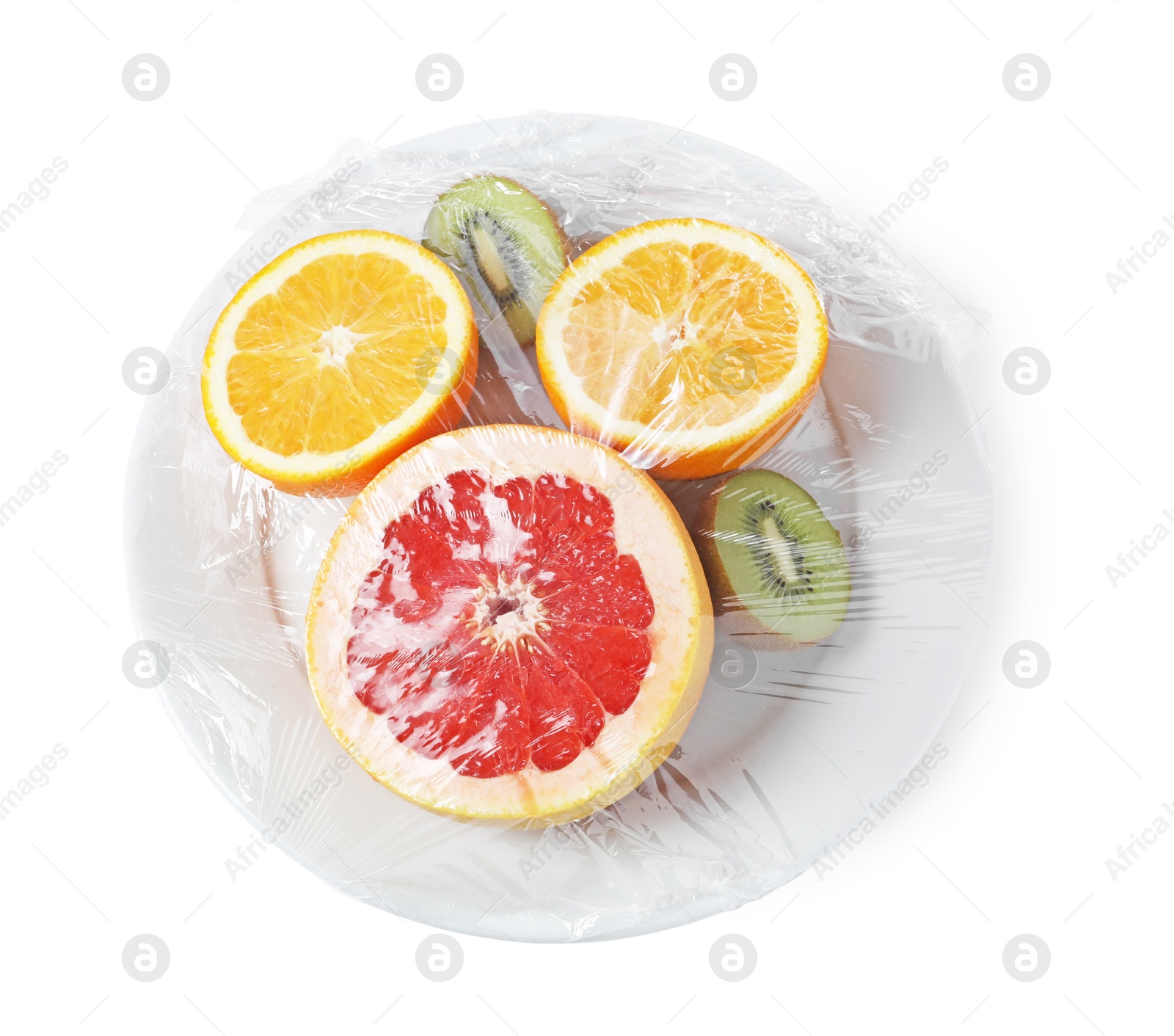 Photo of Plate of fresh fruits with plastic food wrap isolated on white, top view