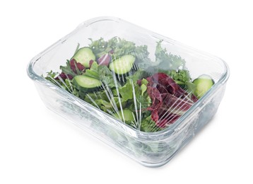 Glass container of fresh salad with plastic food wrap isolated on white