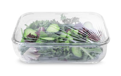 Photo of Glass container of fresh salad with plastic food wrap isolated on white