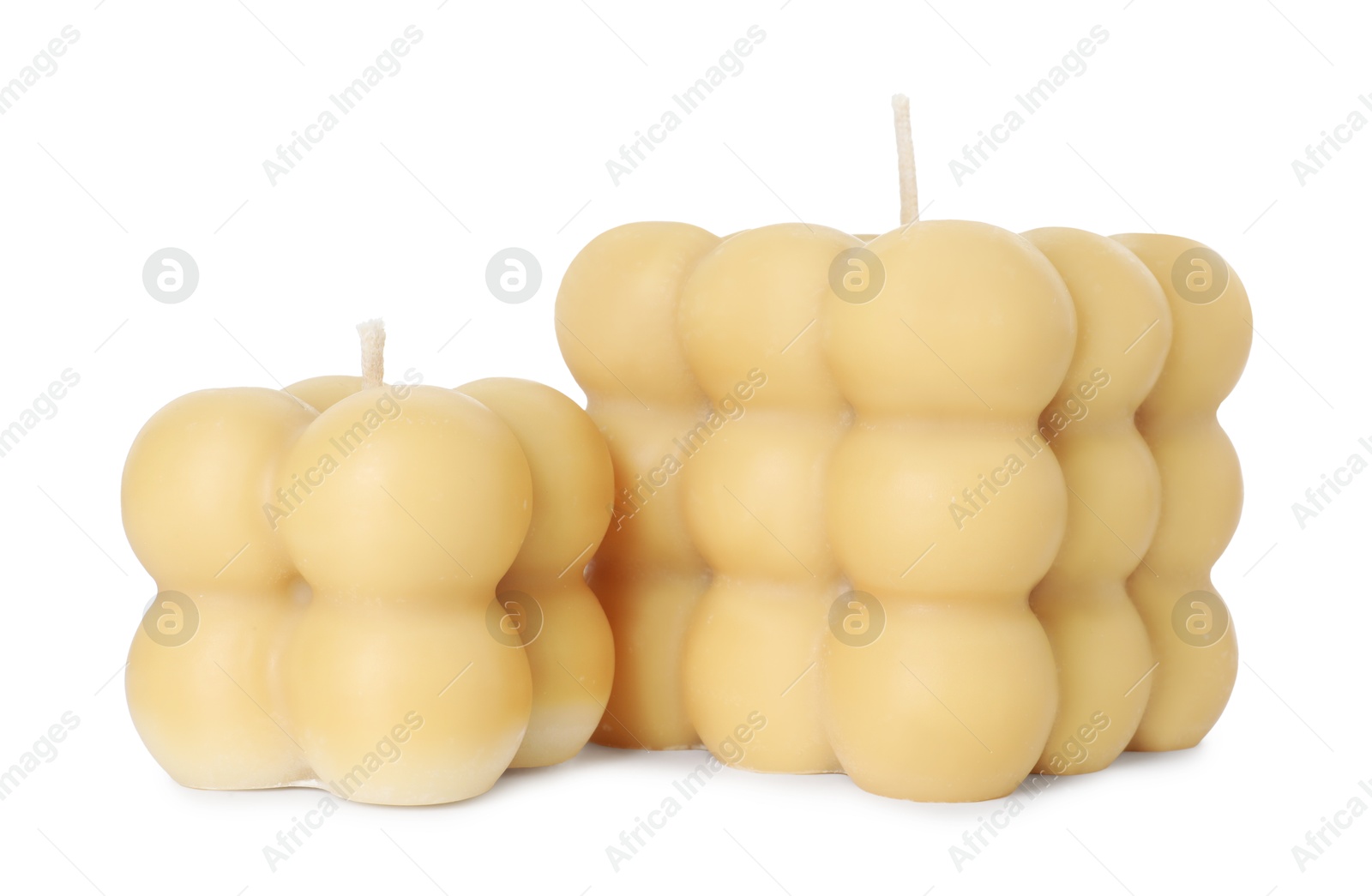 Photo of Two beige bubble candles isolated on white