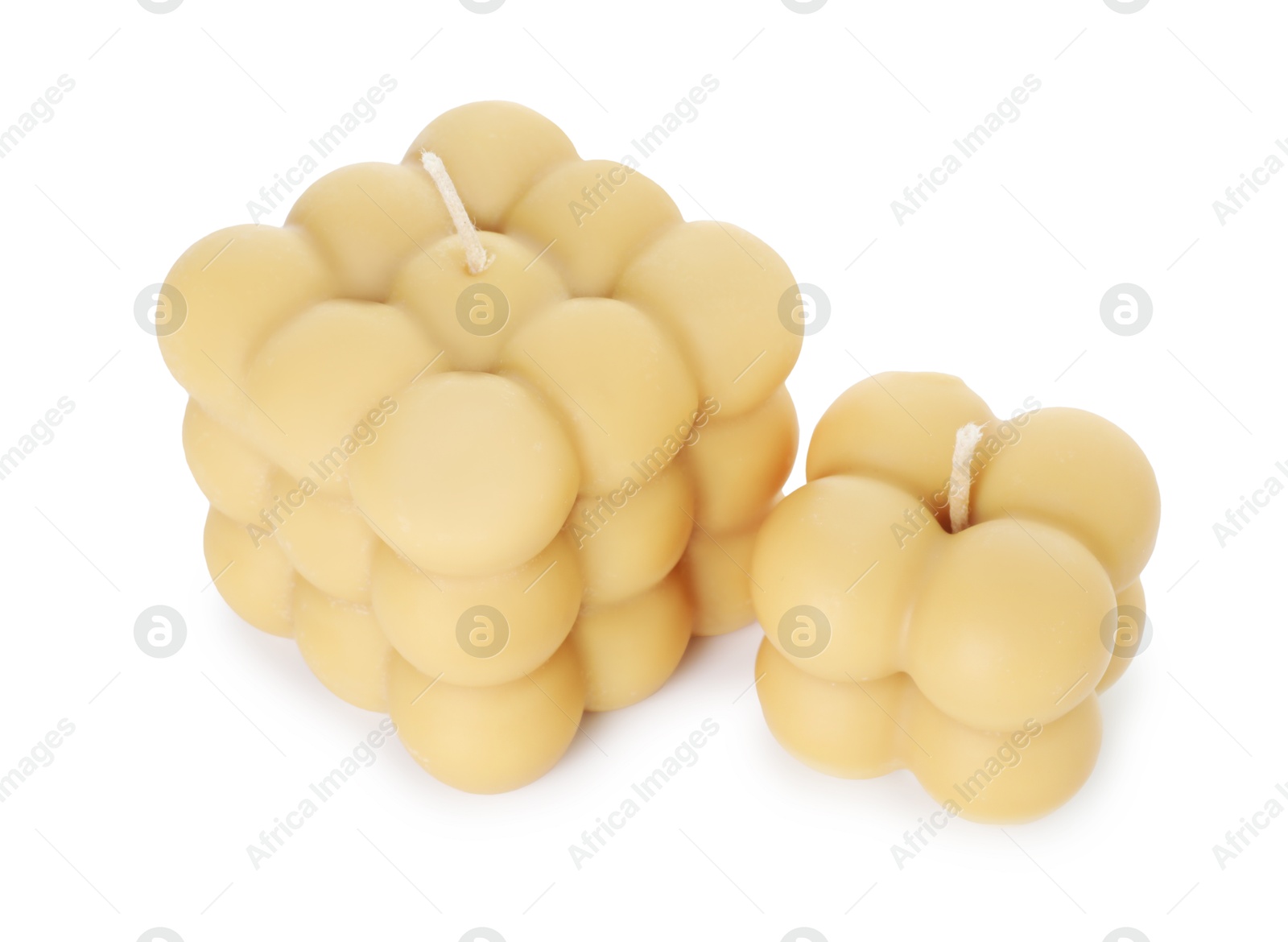 Photo of Two beige bubble candles isolated on white