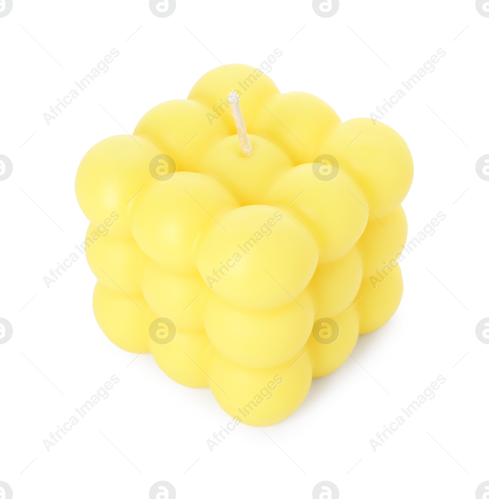 Photo of One yellow bubble candle isolated on white