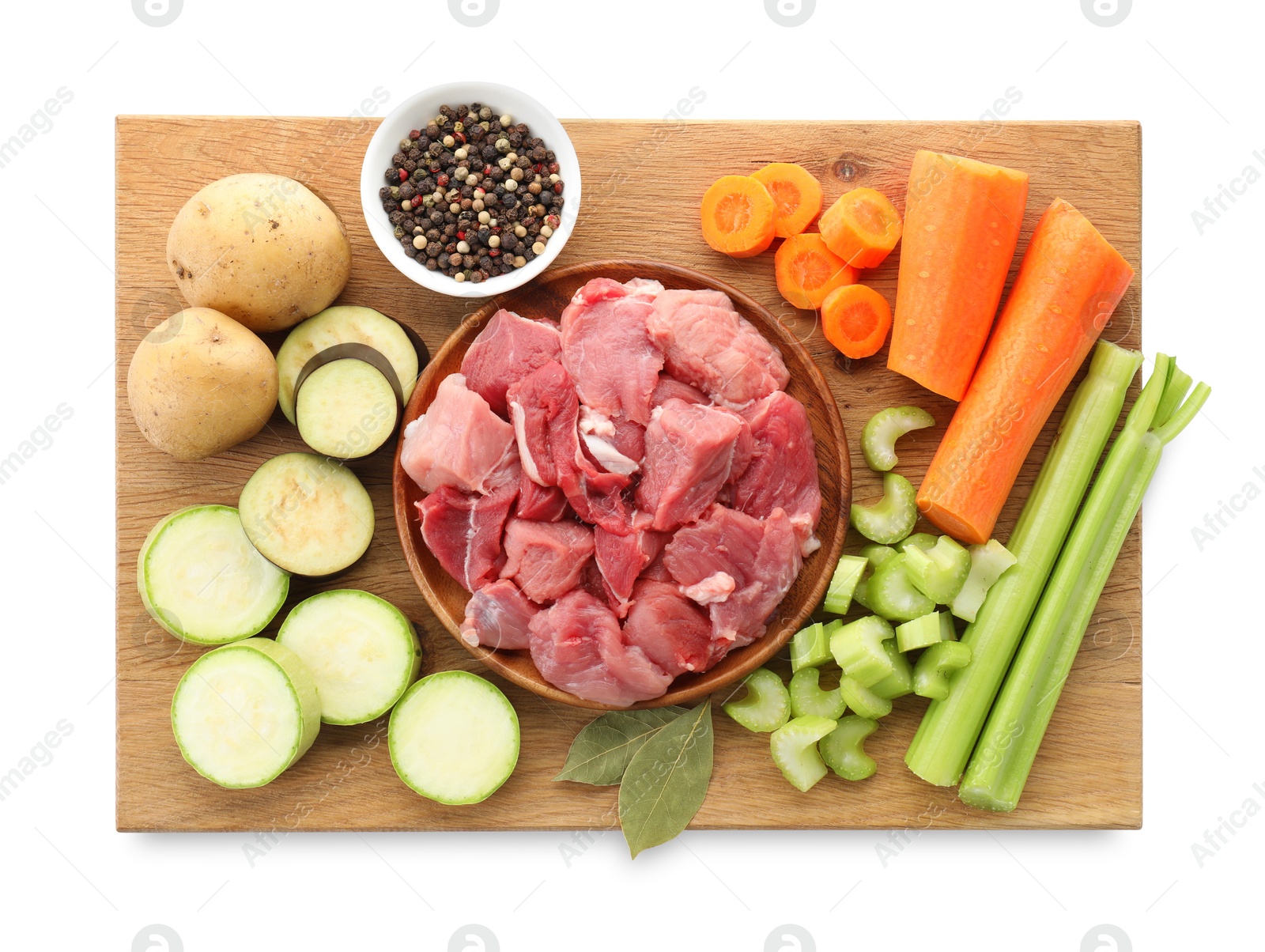 Photo of Cooking stew. Uncooked meat and vegetables isolated on white, top view