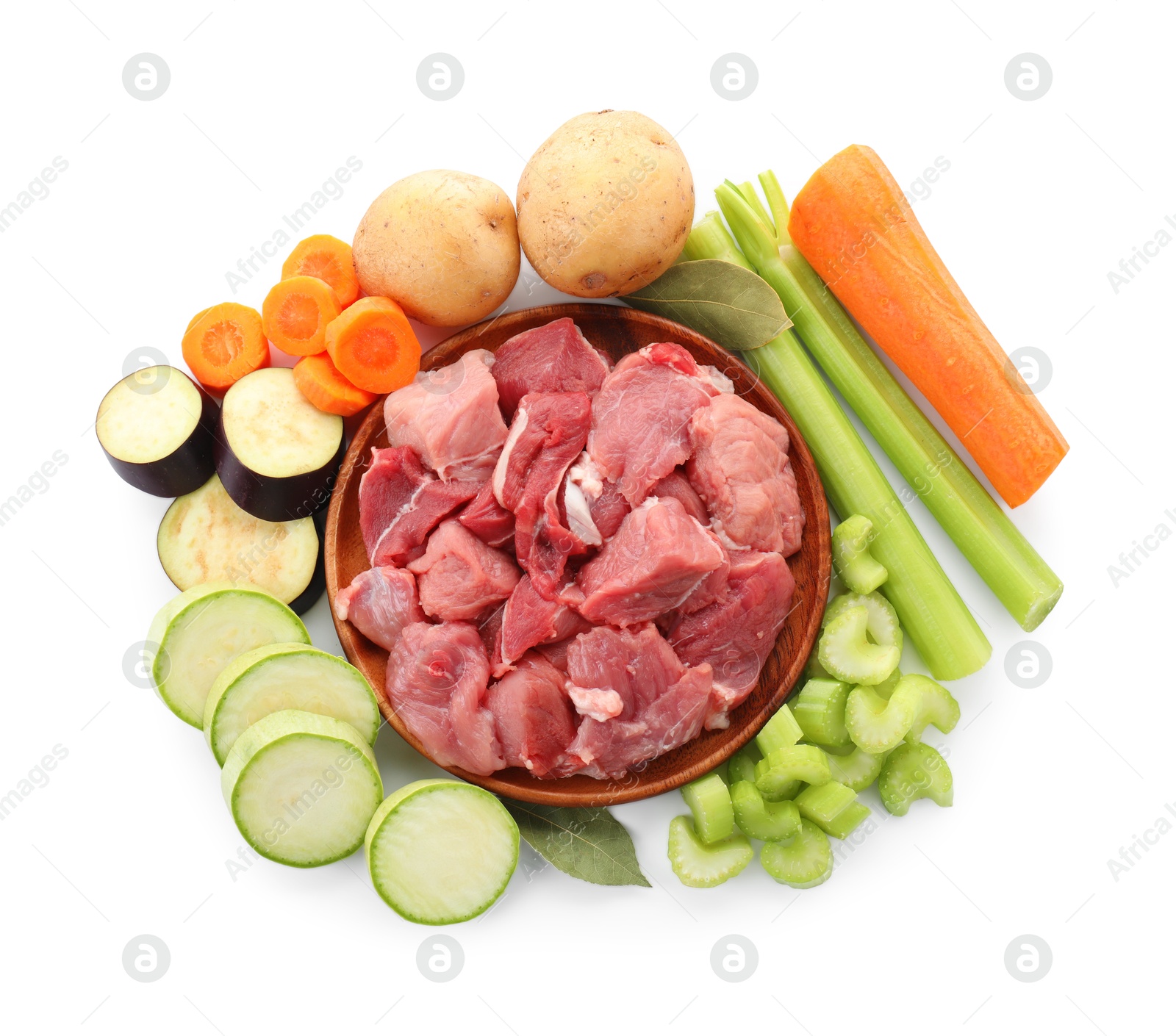 Photo of Cooking stew. Uncooked meat and vegetables isolated on white, top view