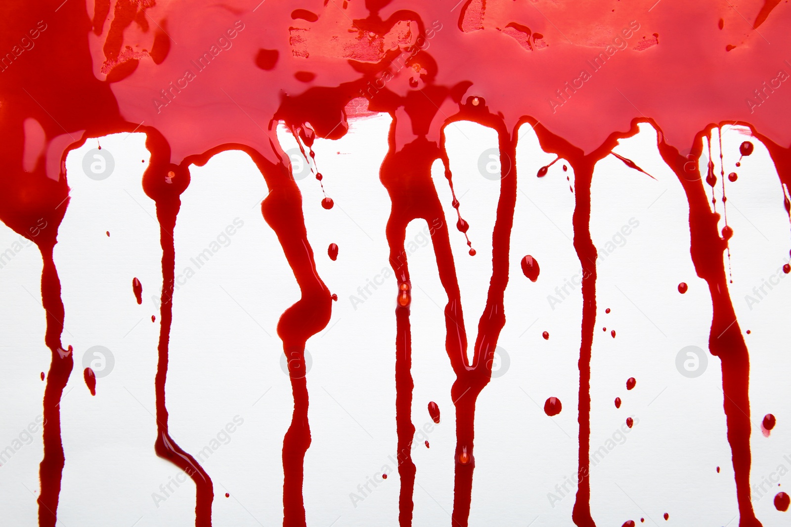 Photo of Leaking red blood stain on white background