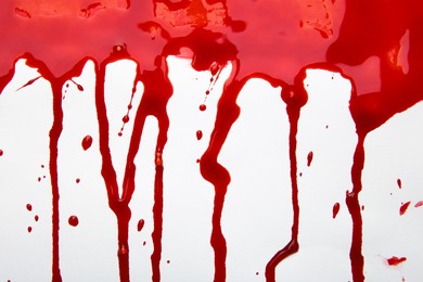 Photo of Leaking red blood stain on white background