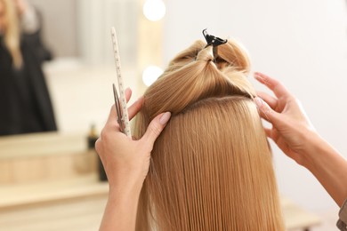 Photo of Hair cutting. Professional hairdresser working with client in salon, closeup