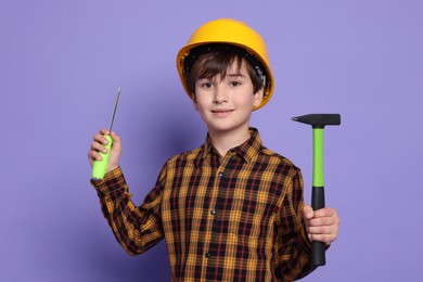 Photo of Boy with tools on violet background. Dreaming of future profession