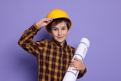 Photo of Boy with house plan pretending to be architect on violet background. Dreaming of future profession