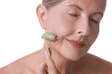 Photo of Beautiful woman doing facial massage with roller on white background