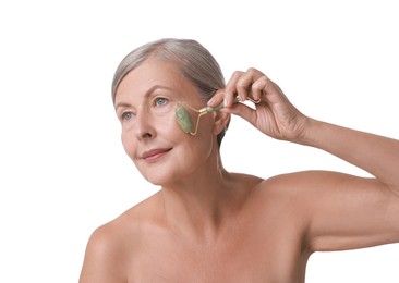 Photo of Beautiful woman doing facial massage with roller on white background