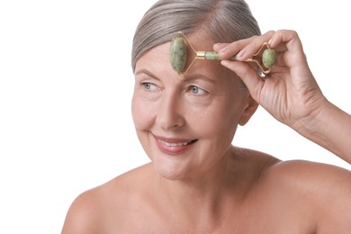 Photo of Beautiful woman doing facial massage with roller on white background