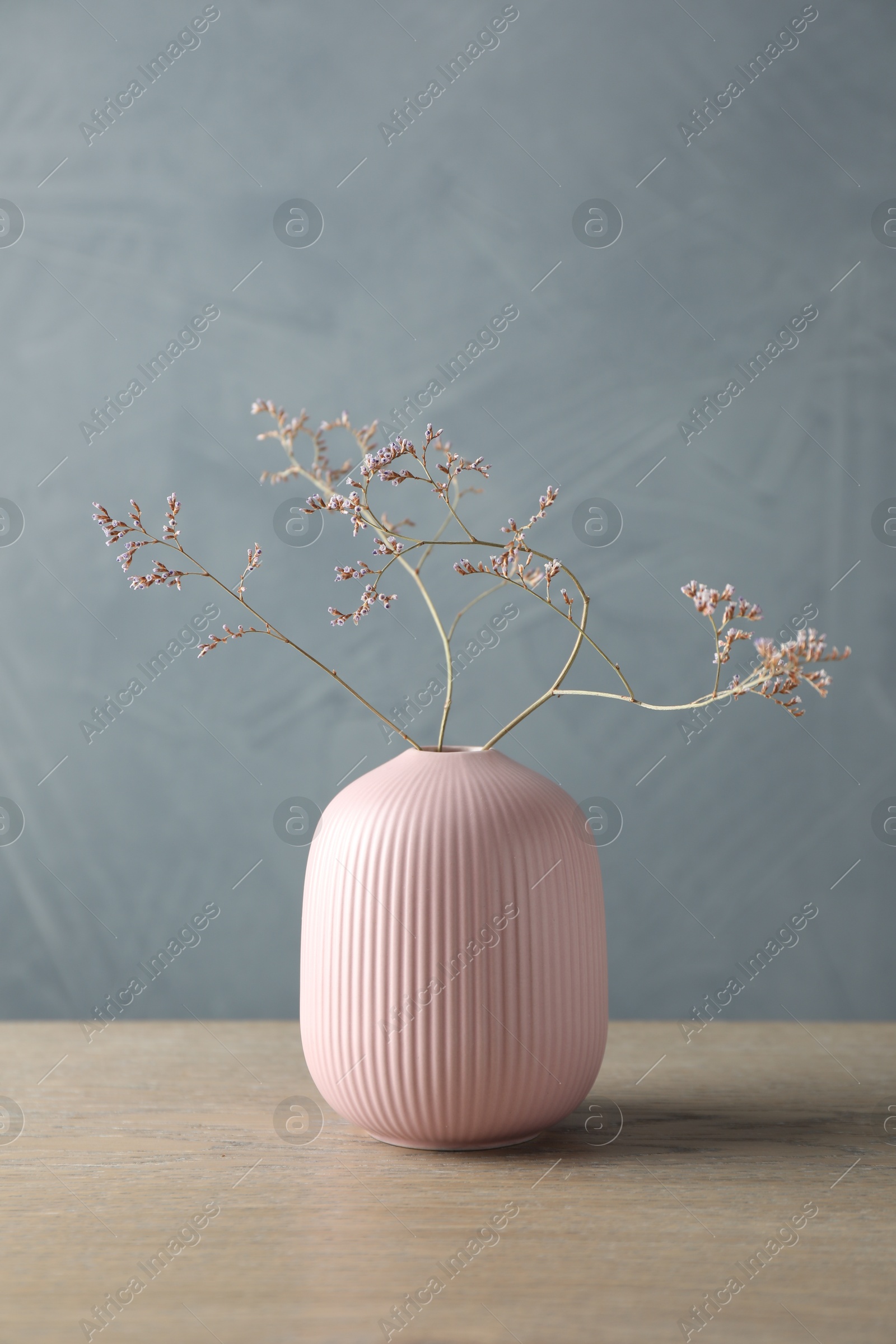 Photo of Stylish vase with beautiful branches on wooden table