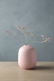 Stylish vase with beautiful branches on wooden table