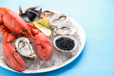 Many different sea food on light blue wooden table, closeup