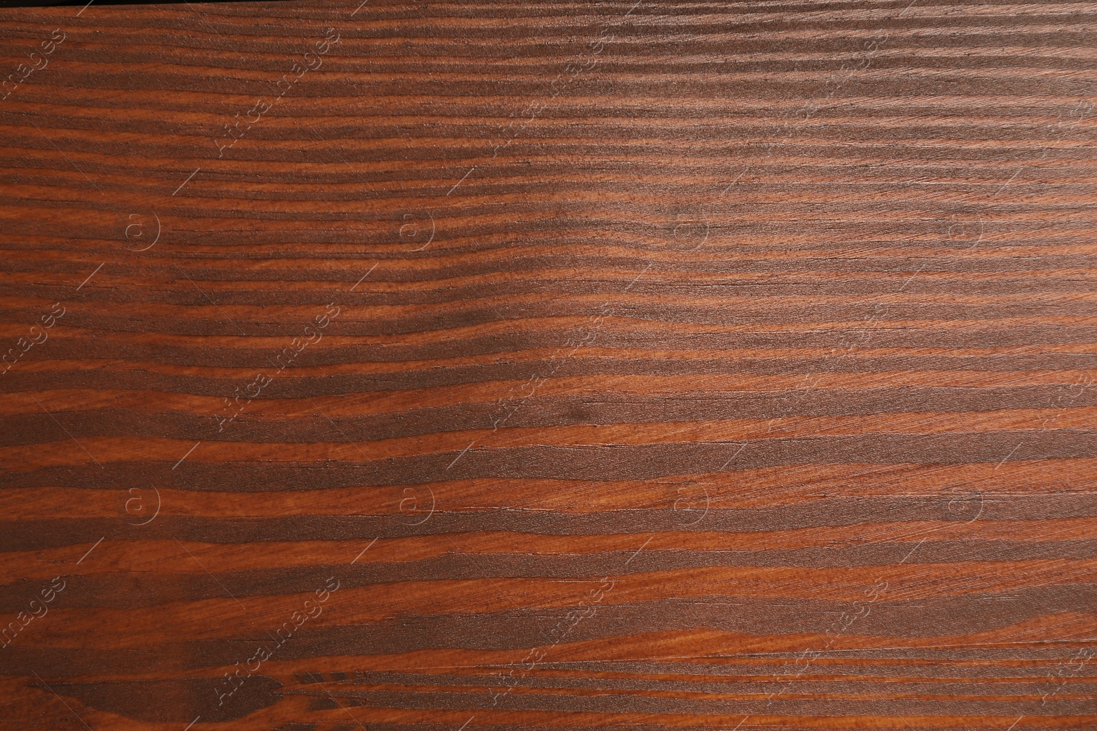 Photo of Applying walnut wood stain. Texture of wooden surface as background, top view