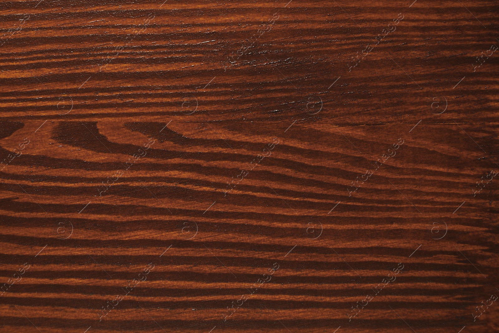 Photo of Texture of wooden surface after applying walnut wood stain as background, top view