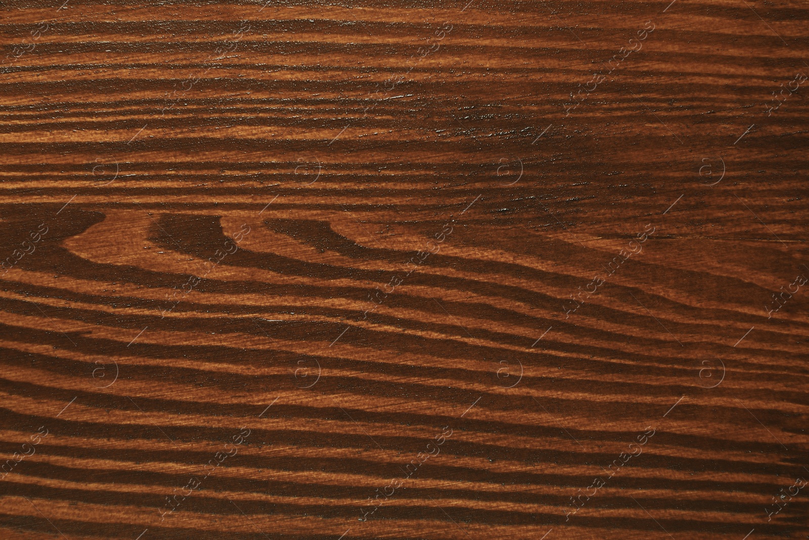 Photo of Texture of wooden surface after applying walnut wood stain as background, top view