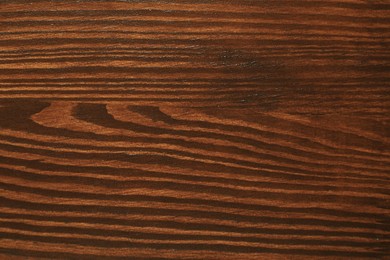 Photo of Texture of wooden surface after applying walnut wood stain as background, top view