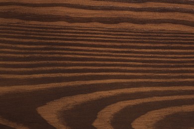 Photo of Texture of wooden surface after applying walnut wood stain as background, closeup