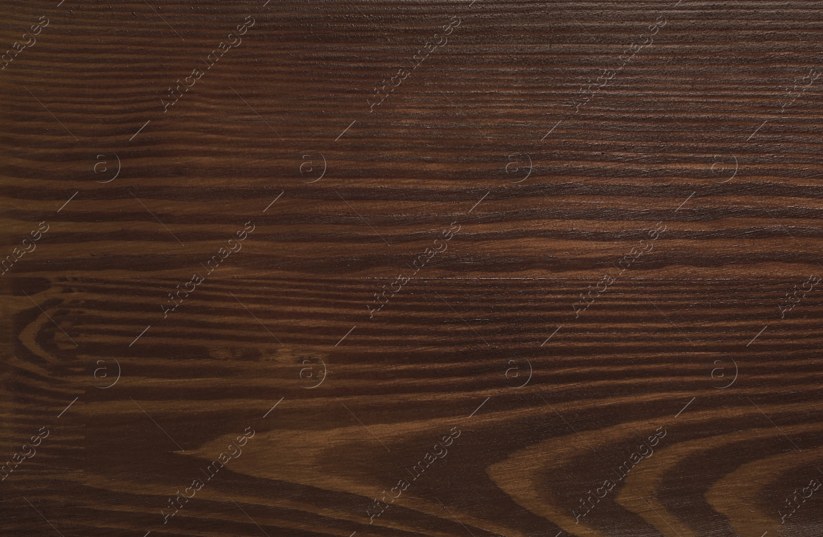 Photo of Texture of wooden surface after applying walnut wood stain as background, top view