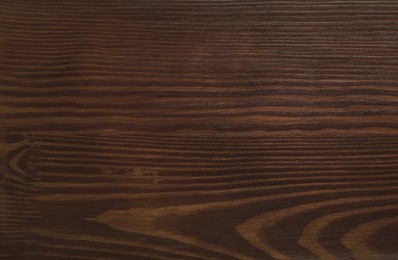 Photo of Texture of wooden surface after applying walnut wood stain as background, top view