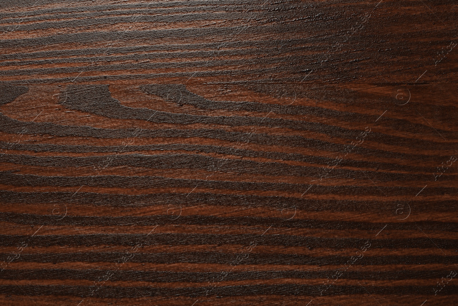 Photo of Texture of wooden surface after applying walnut wood stain as background, top view