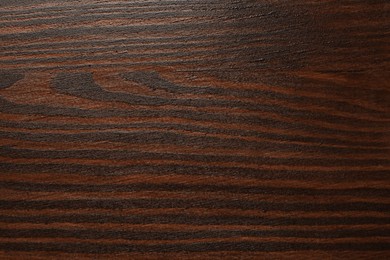 Photo of Texture of wooden surface after applying walnut wood stain as background, top view