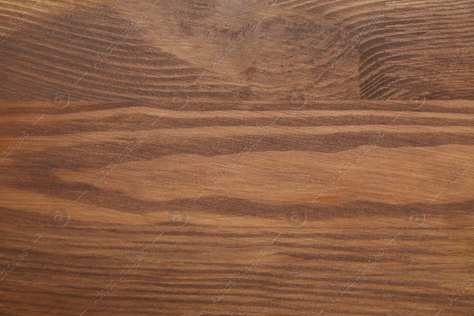 Photo of Applying walnut wood stain. Texture of wooden surface as background, top view